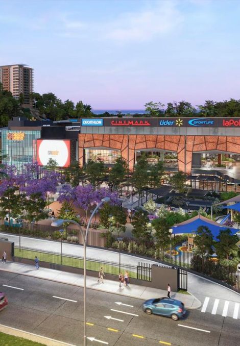 Imagen al atardecer del centro comercial Espacio Urbano 15 Norte, destacando la fachada iluminada, el parque infantil techado en primer plano y los logos de tiendas como Sodimac, Falabella, Cinemark y La Polar.