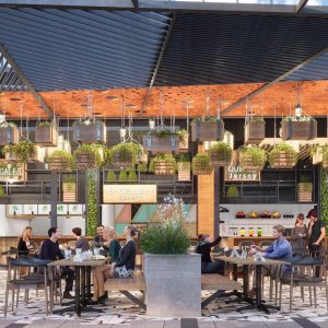 Personas compartiendo en mesas de una terraza gastronómica con techos metálicos, plantas colgantes y locales como El Granero, Gales y Dunkin’ Donuts al fondo en Espacio Urbano 15 Norte.
